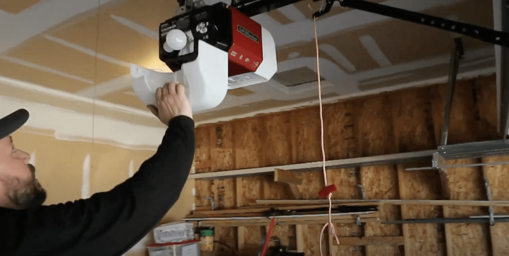 Dr. Door service professional repairing a LiftMaster garage door opener. 